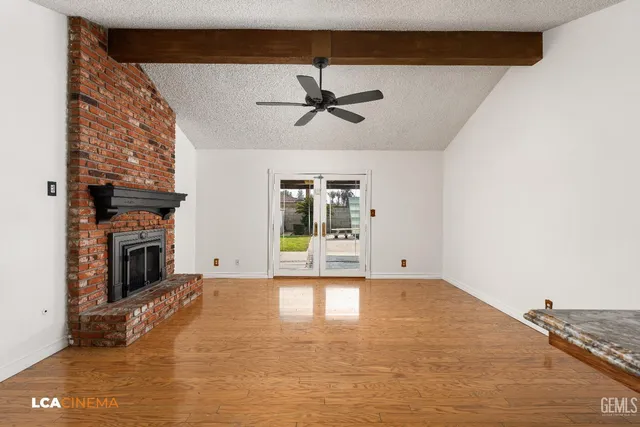 a view of a livingroom with a fireplace and window