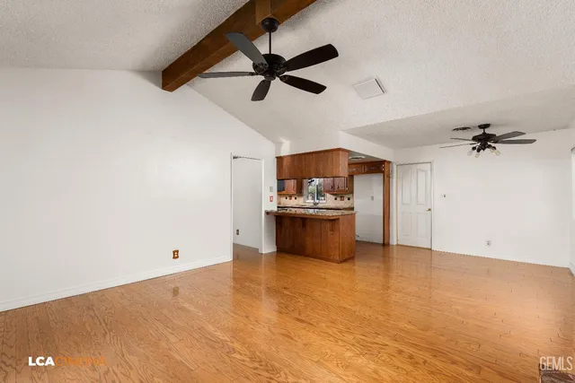 a view of a kitchen with a sink cabinets and wooden floor