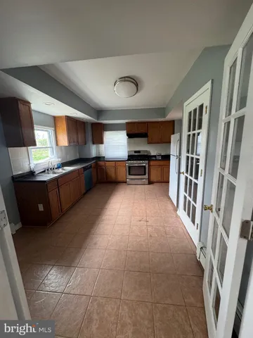 a kitchen with stainless steel appliances granite countertop a stove and a refrigerator