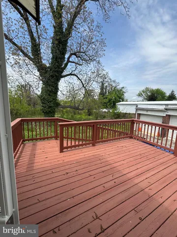 a view of balcony with wooden floor and fence