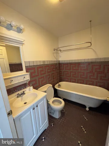 a bathroom with a sink a toilet and bathtub