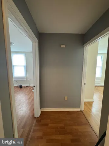 a view of a room with wooden floor and windows