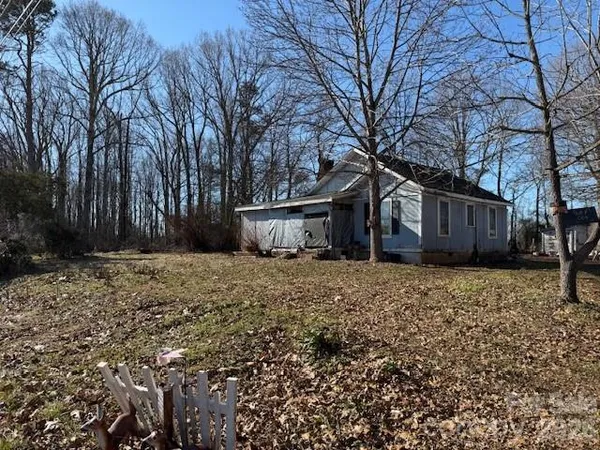 a front view of house with a garden