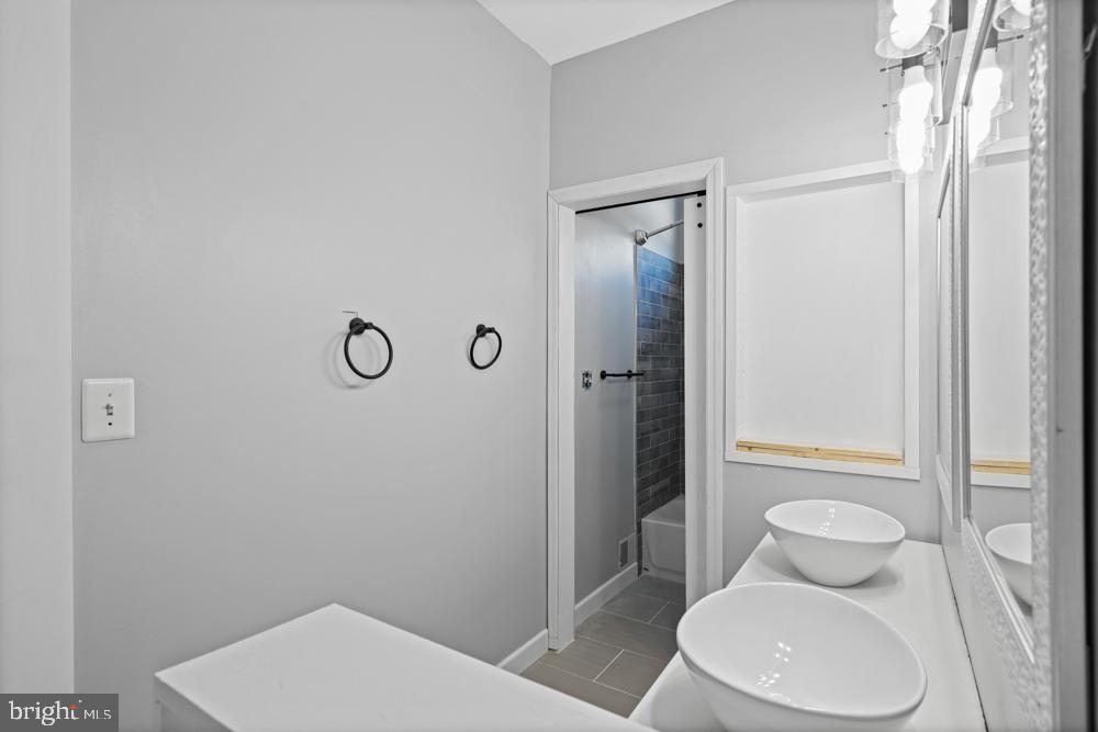 13710 Baden Naylor Road Upper Marlboro, MD 20772 - Photo 41 of 66 a white toilet sitting next to a bathroom sink