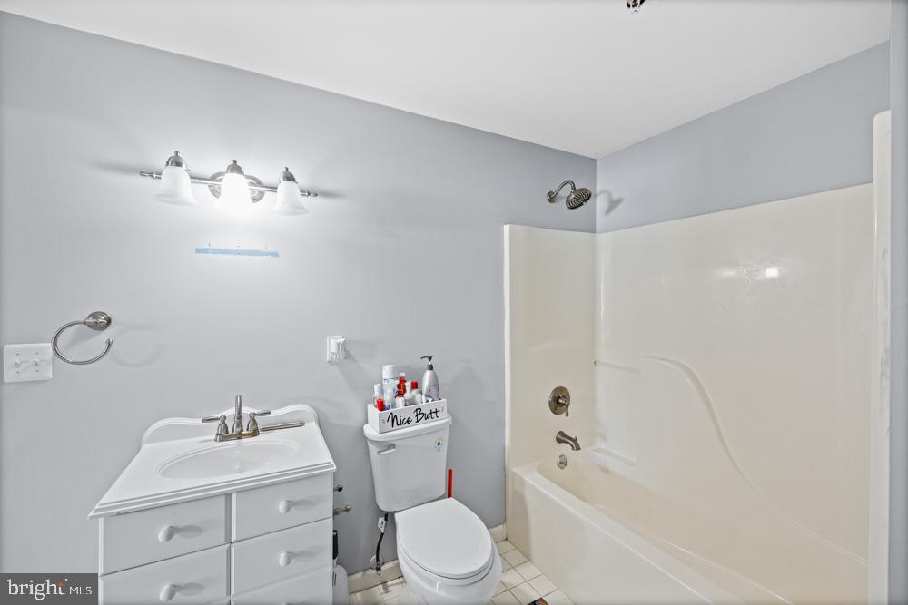 13710 Baden Naylor Road Upper Marlboro, MD 20772 - Photo 53 of 66 a bathroom with a sink toilet and shower