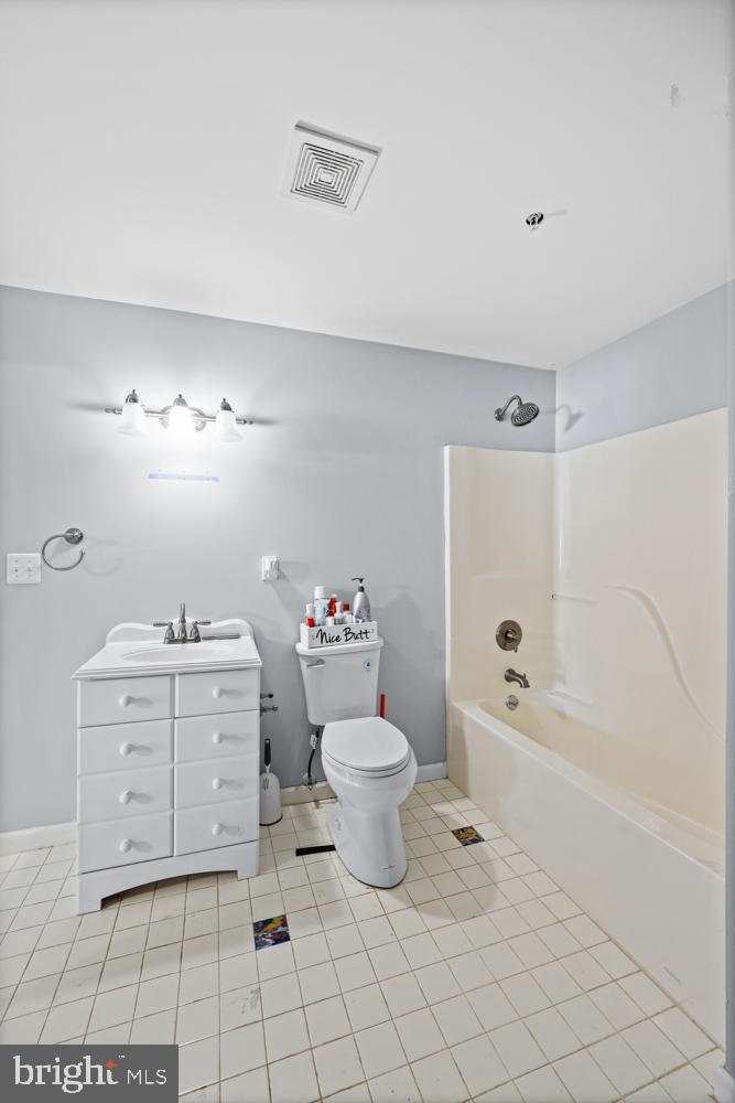 13710 Baden Naylor Road Upper Marlboro, MD 20772 - Photo 54 of 66 a bathroom with a sink toilet vanity and tub