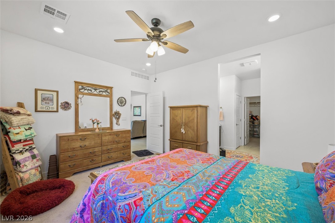 4743 South Springridge Street Pahrump, NV 89061 - Photo 23 of 50 Bedroom featuring recessed lighting, light colored carpet, ceiling fan, and ensuite bath