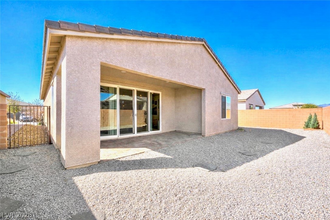 4743 South Springridge Street Pahrump, NV 89061 - Photo 32 of 50 Rear view of house featuring a patio, a fenced backyard, stucco siding, and a tiled roof