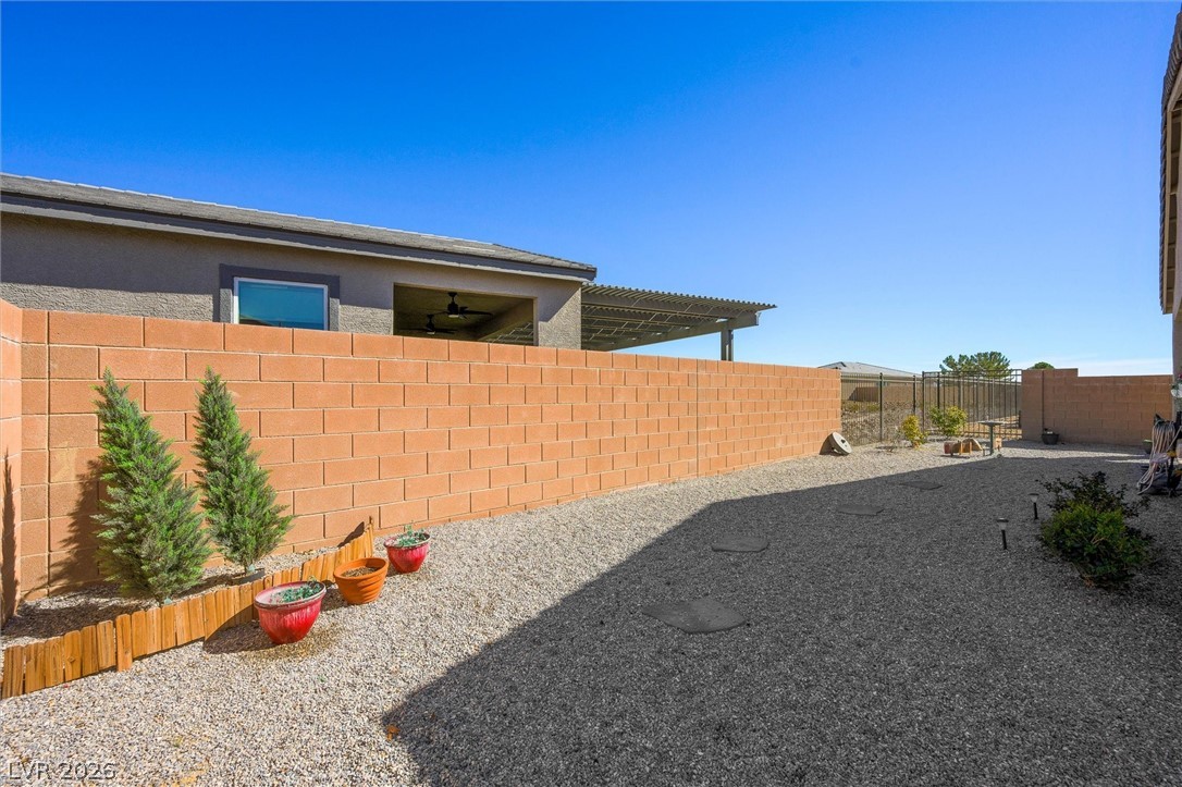 4743 South Springridge Street Pahrump, NV 89061 - Photo 35 of 50 Fenced backyard with a patio and area for grilling