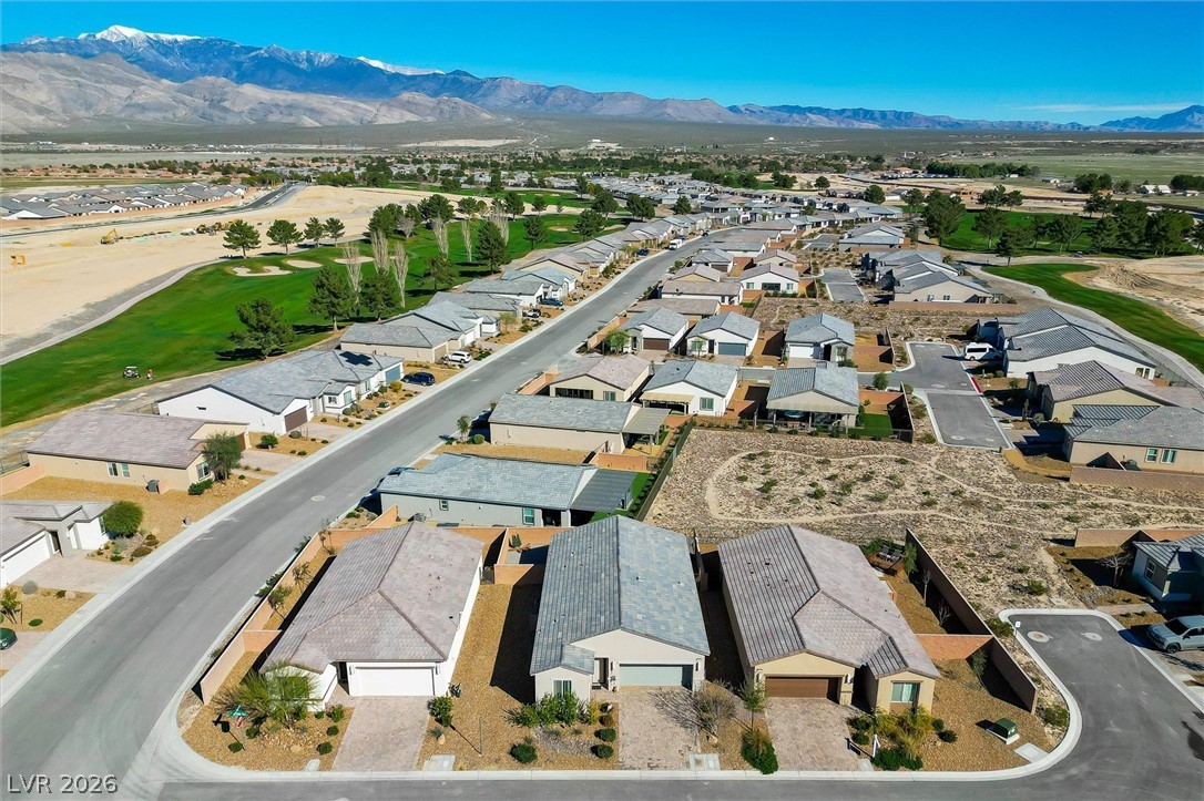 4743 South Springridge Street Pahrump, NV 89061 - Photo 39 of 50 Aerial view of residential area featuring a golf course and mountains