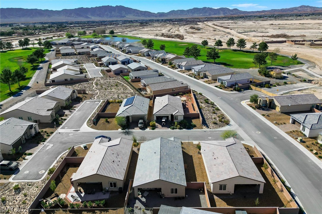 4743 South Springridge Street Pahrump, NV 89061 - Photo 44 of 50 Aerial view of residential area with a golf club and a water and mountain view