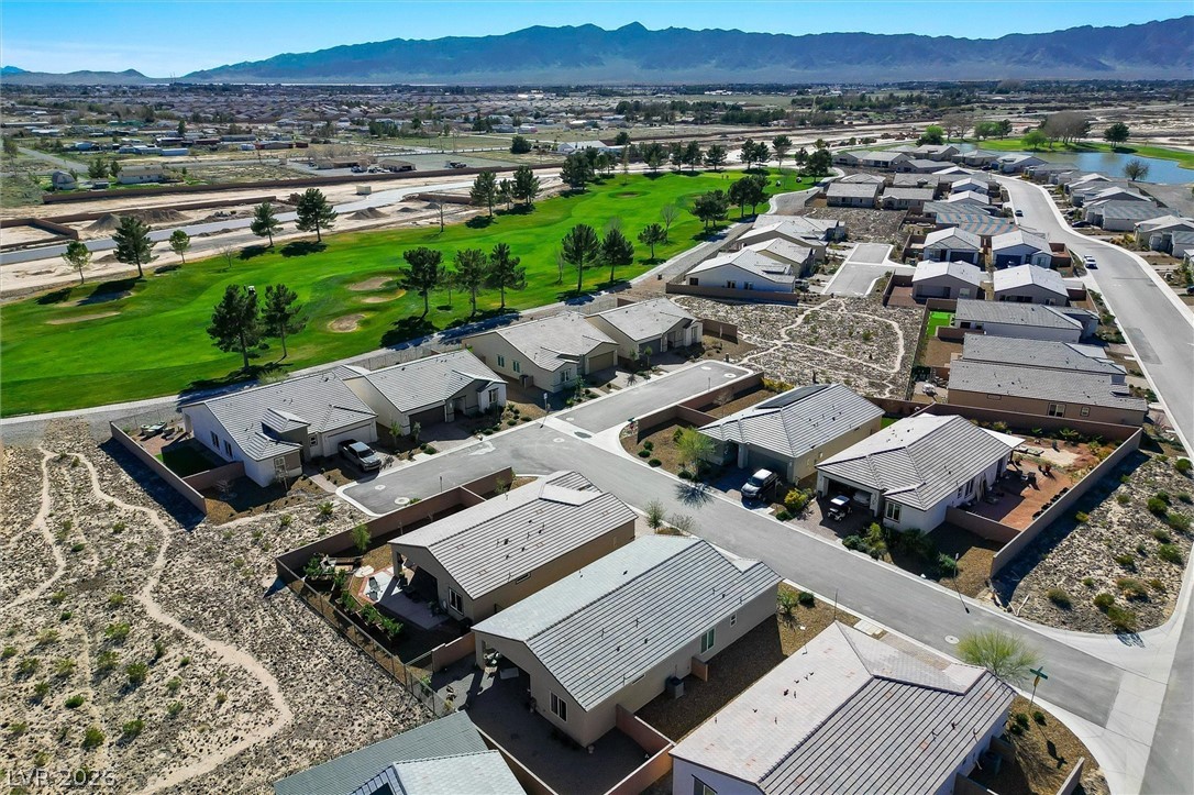 4743 South Springridge Street Pahrump, NV 89061 - Photo 45 of 50 Aerial view of residential area with mountains and a golf course