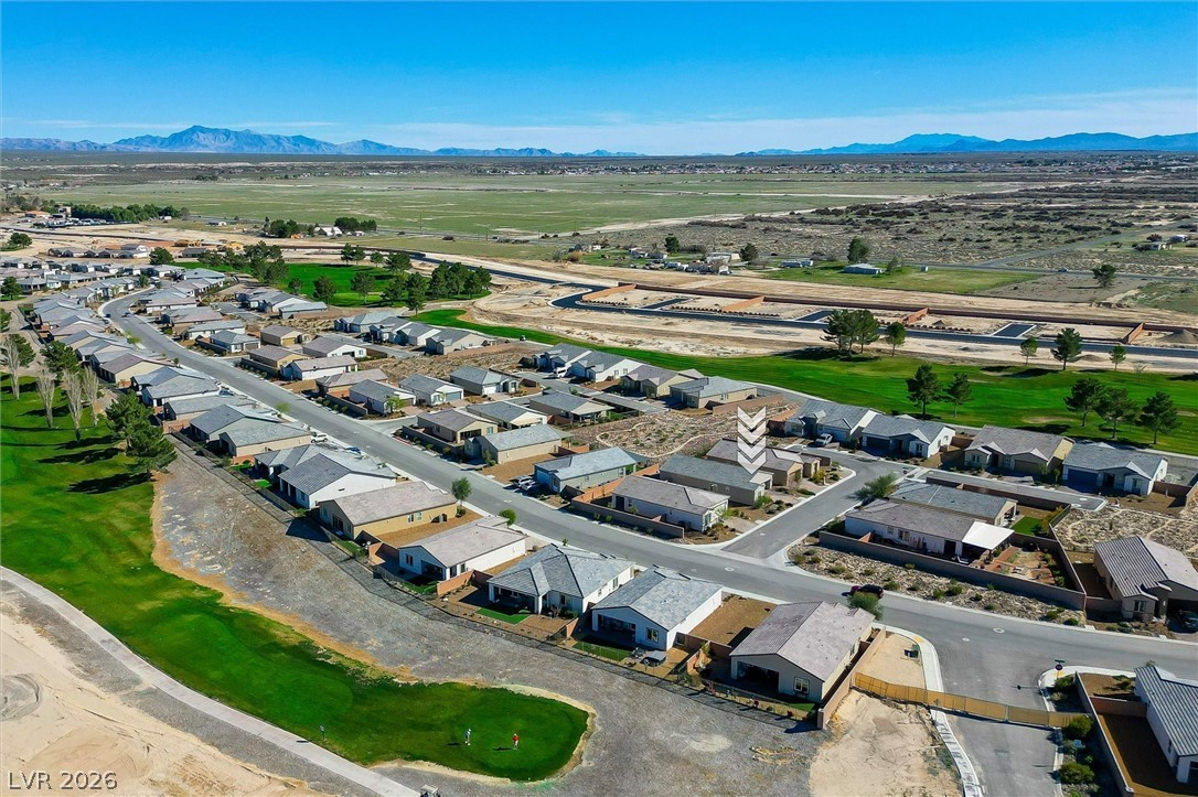 4743 South Springridge Street Pahrump, NV 89061 - Photo 46 of 50 Aerial view of property and surrounding area featuring a mountain backdrop and nearby suburban area