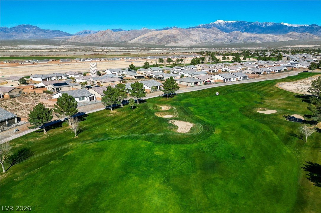 4743 South Springridge Street Pahrump, NV 89061 - Photo 48 of 50 Aerial perspective of suburban area with a golf course and a mountain backdrop