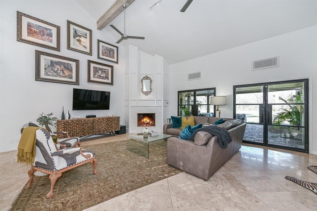 1038 Winner Foster Road Richmond, TX 77406 - Photo 17 of 37 a living room with furniture a flat screen tv and a fireplace