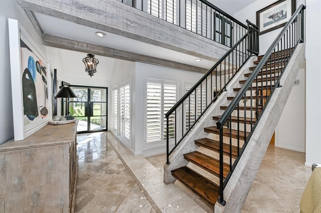 1038 Winner Foster Road Richmond, TX 77406 - Photo 18 of 37 a view of staircase with lots of frames on wall and windows
