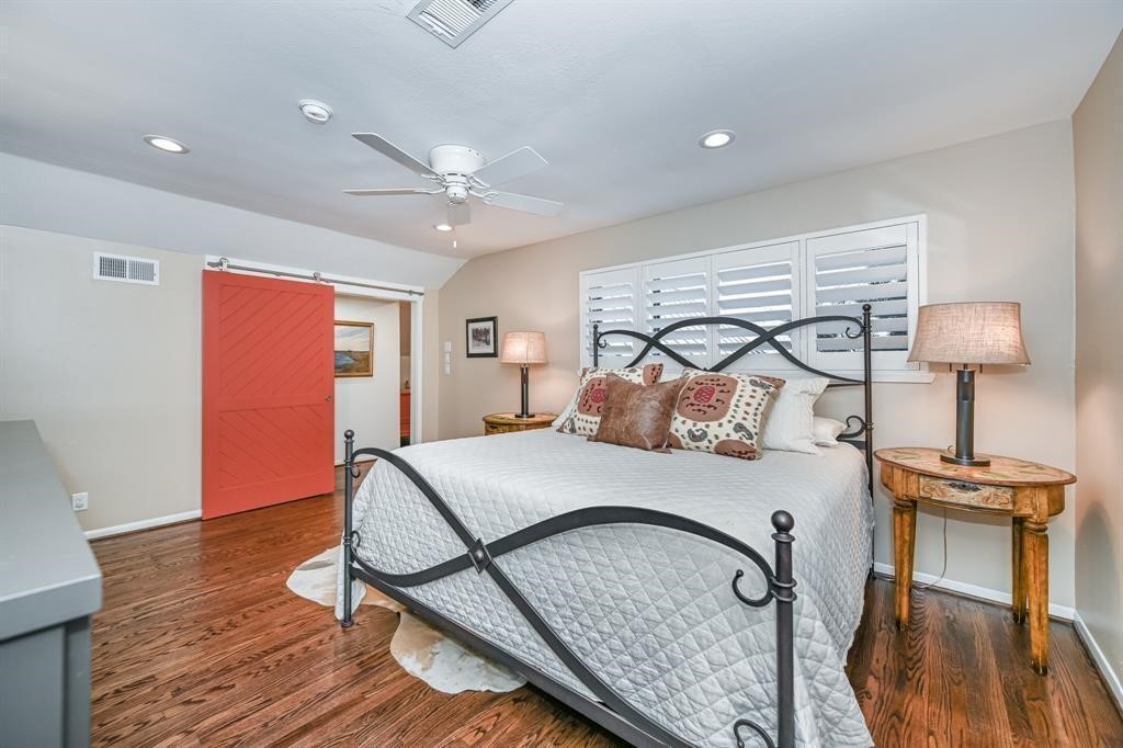 1038 Winner Foster Road Richmond, TX 77406 - Photo 32 of 37 a bedroom with a bed and wooden floor