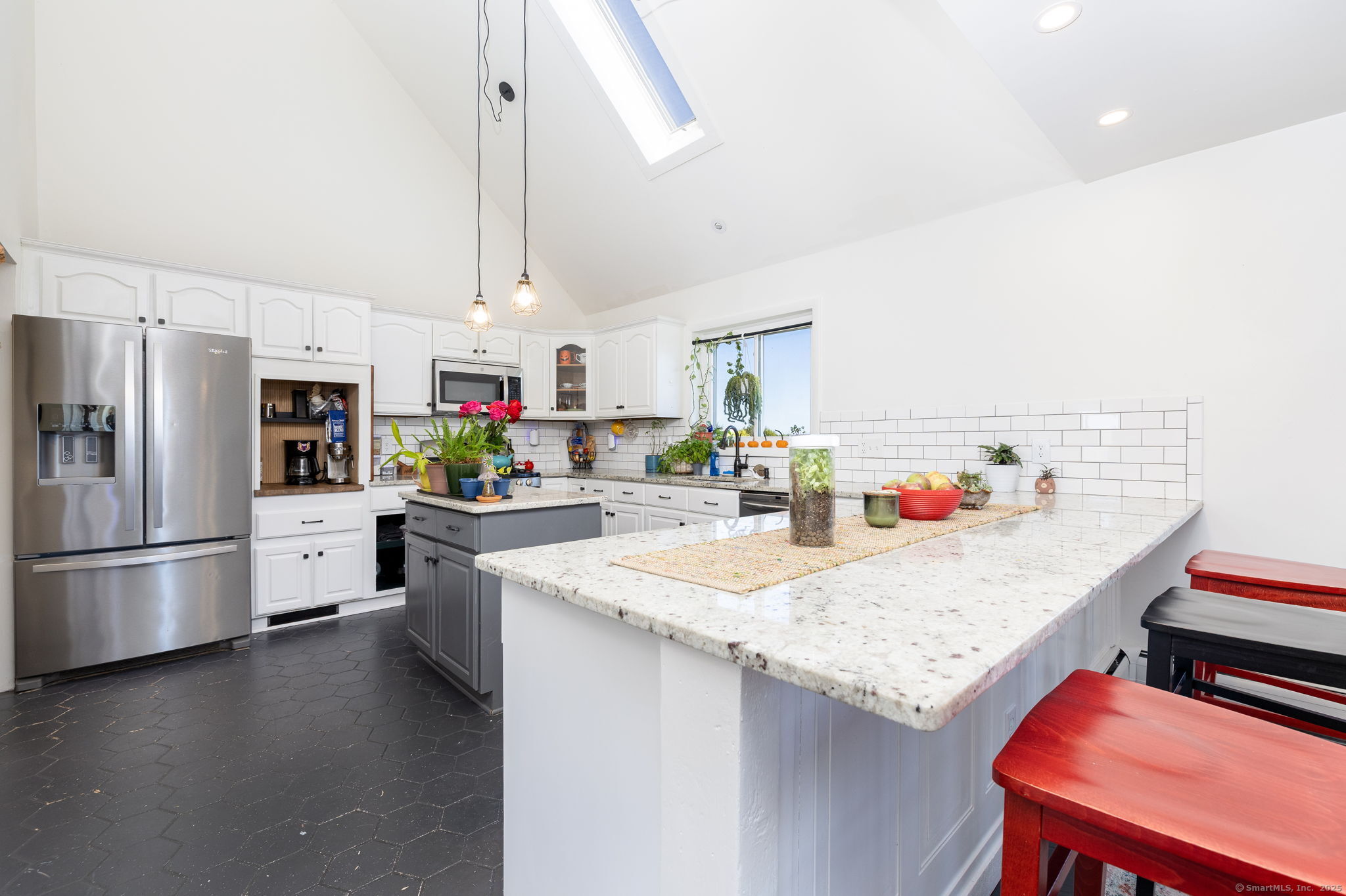 57 Bayview Circle Watertown, CT 06795 - Photo 19 of 40 a kitchen with a refrigerator a stove and white cabinets