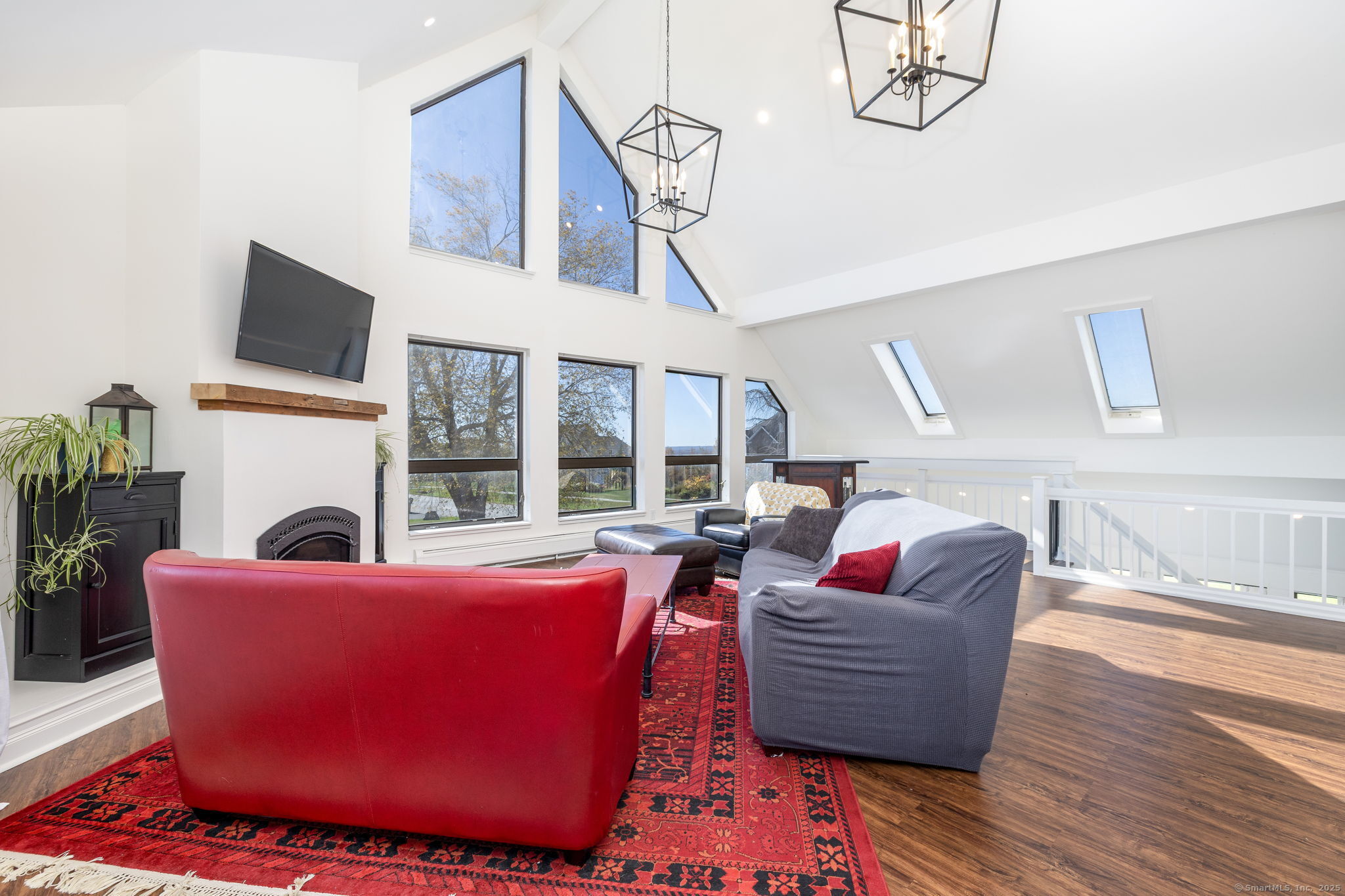 57 Bayview Circle Watertown, CT 06795 - Photo 3 of 40 a living room with furniture a fireplace and a flat screen tv