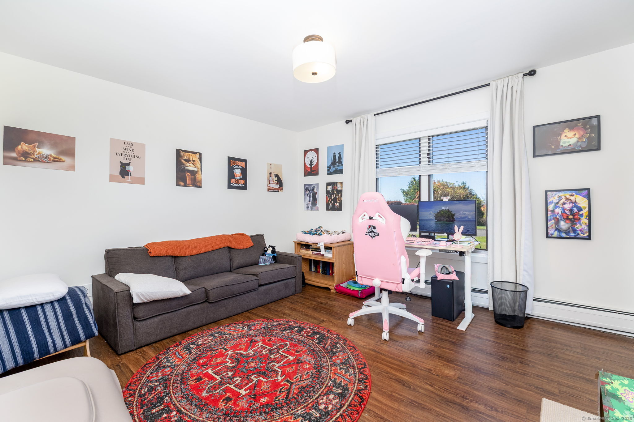 57 Bayview Circle Watertown, CT 06795 - Photo 32 of 40 a living room with furniture and a wooden floor