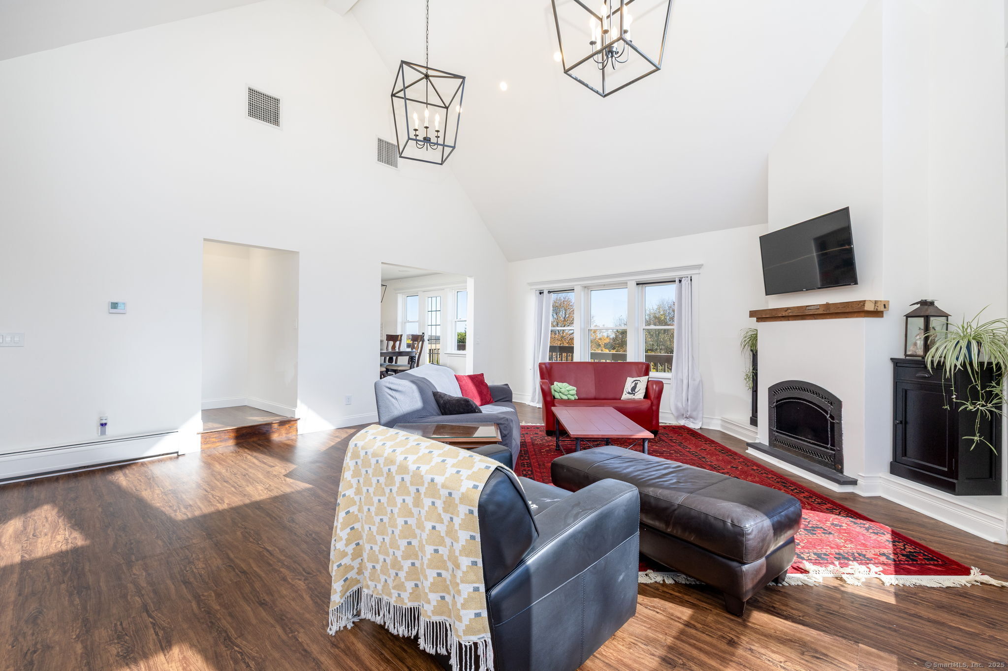 57 Bayview Circle Watertown, CT 06795 - Photo 4 of 40 a living room with furniture a fireplace and wooden floor