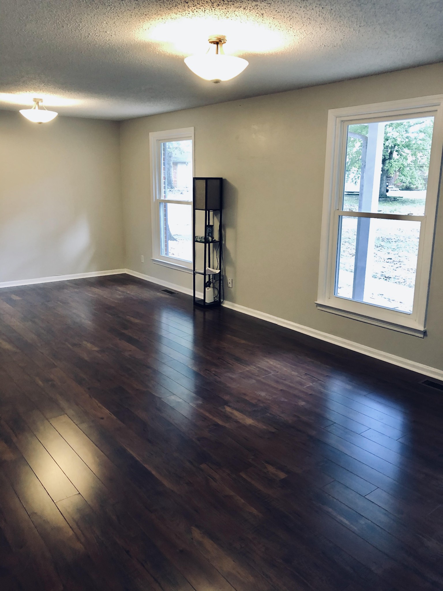 225 Yorktown Road Clarksville, TN 37042 - Photo 4 of 10 an empty room with wooden floor and windows
