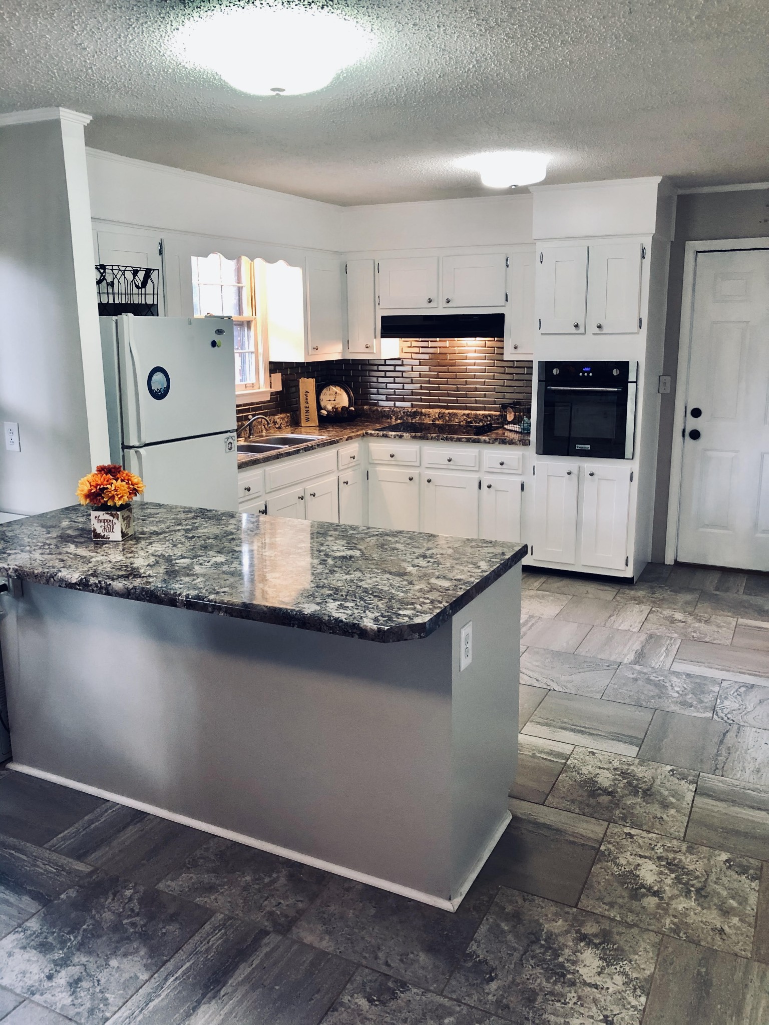 225 Yorktown Road Clarksville, TN 37042 - Photo 5 of 10 a kitchen with stainless steel appliances granite countertop a sink a stove top oven a counter space and cabinets