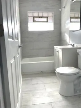 a bathroom with a toilet a sink and bathtub