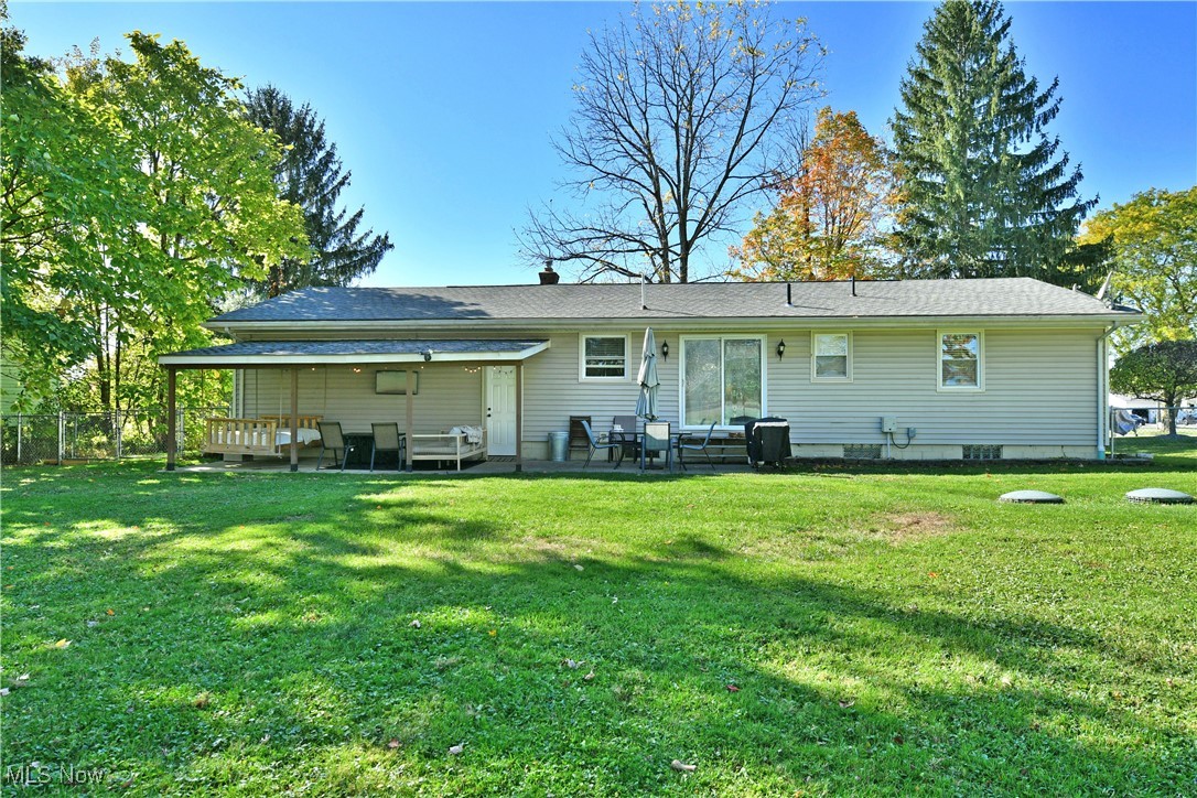4400 Ridge Road Cortland, OH 44410 - Photo 43 of 50 Back of property with roof with shingles, a patio area, and a chimney