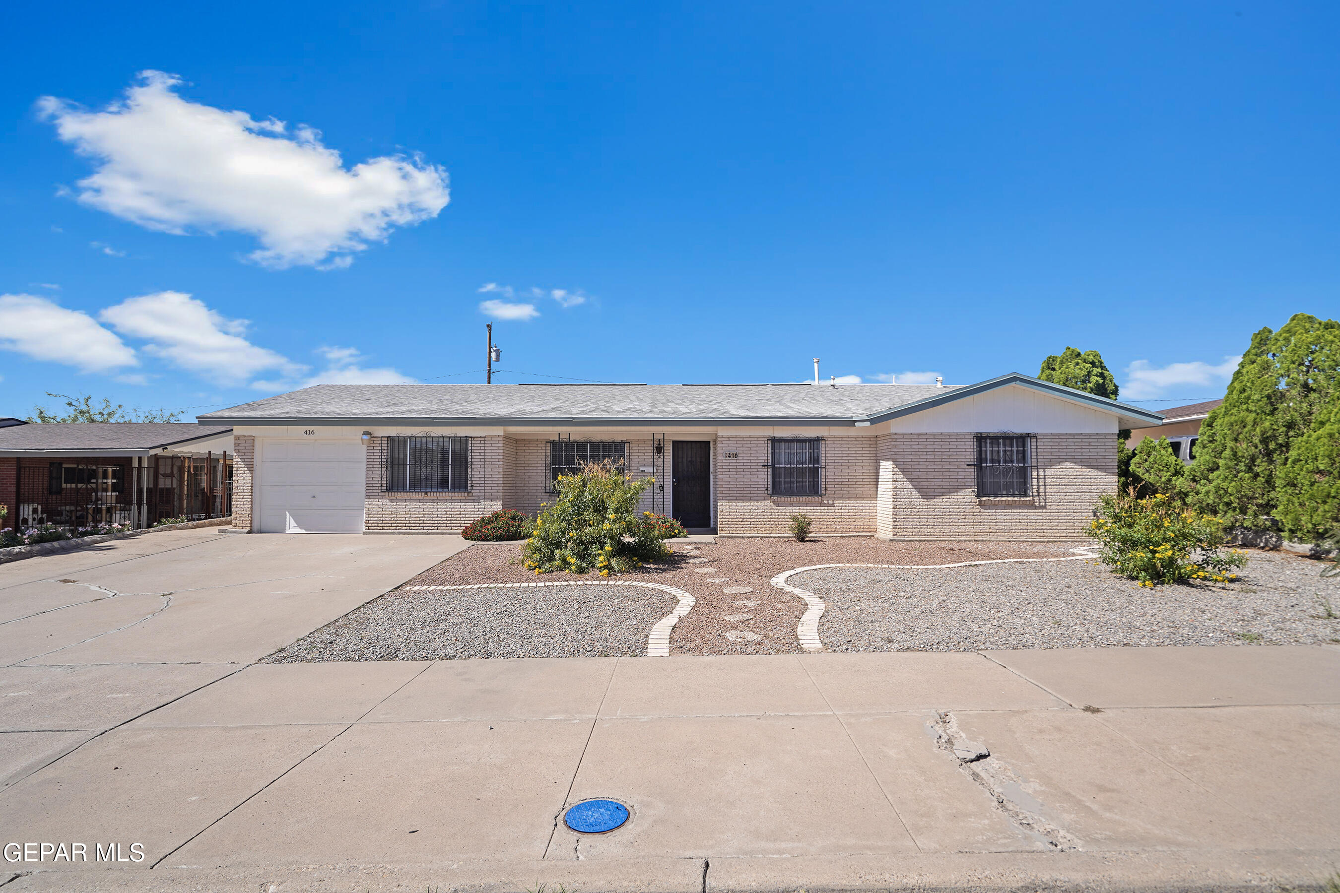 416 San Saba Road El Paso, TX 79912 - Photo 1 of 41 a front view of a house with a yard and a garage