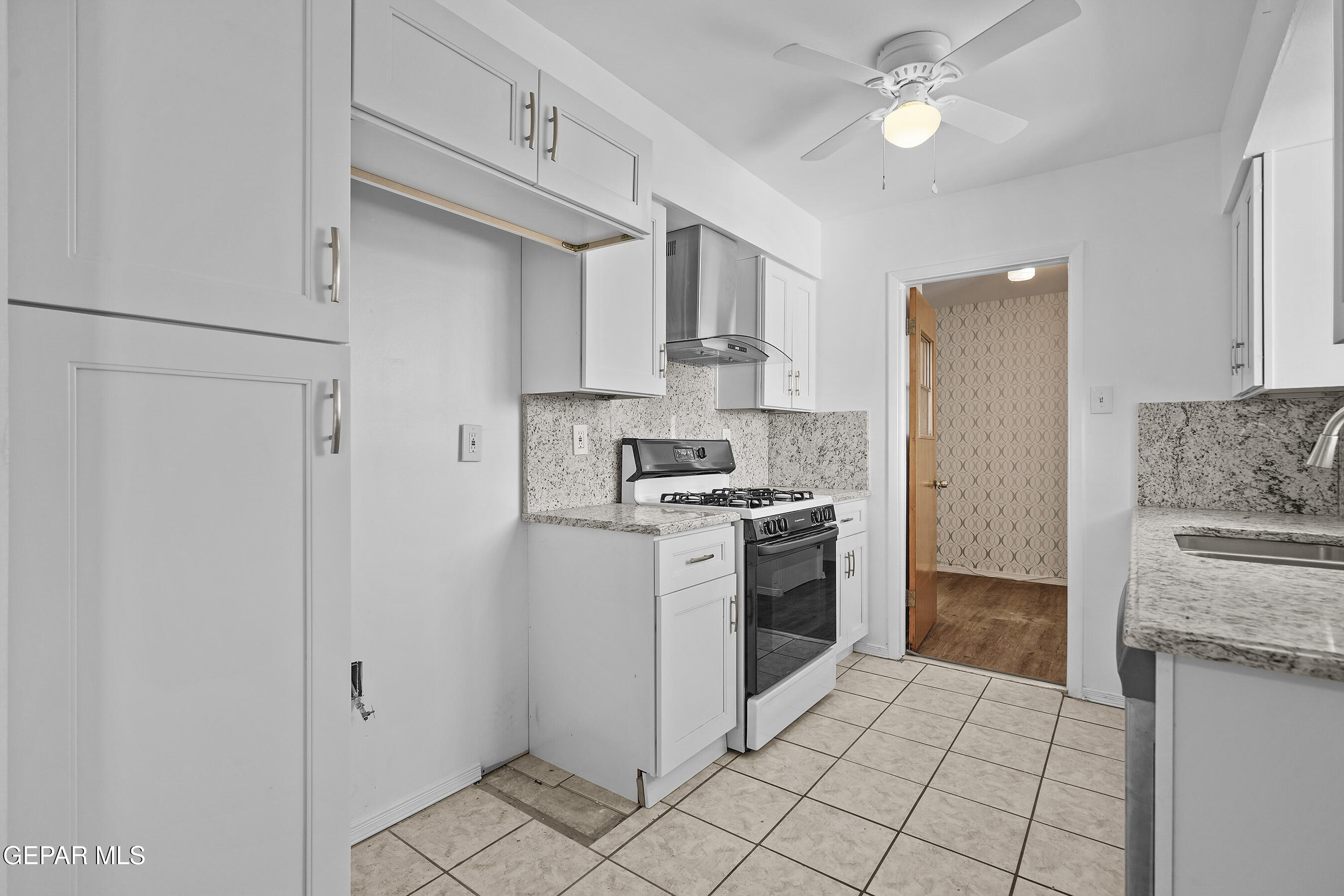 416 San Saba Road El Paso, TX 79912 - Photo 14 of 41 a kitchen with stainless steel appliances granite countertop a refrigerator a stove and a sink