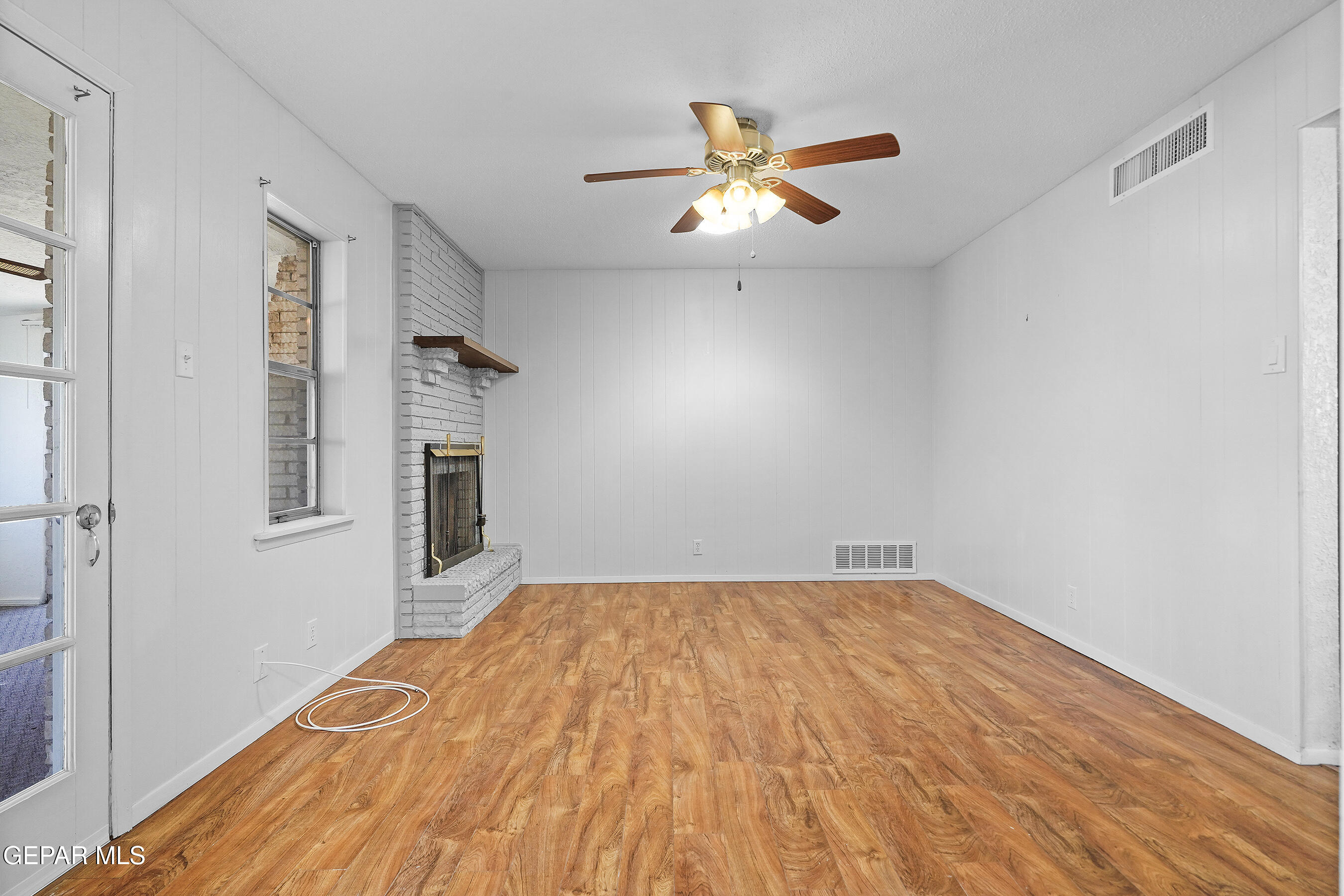 416 San Saba Road El Paso, TX 79912 - Photo 20 of 41 a view of empty room with wooden floor and fan