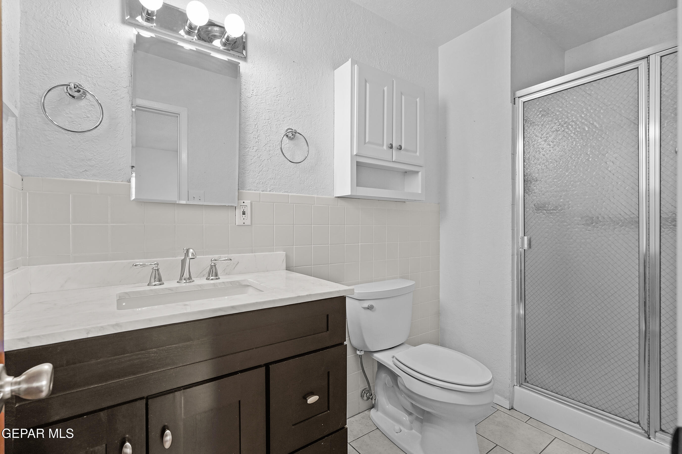 416 San Saba Road El Paso, TX 79912 - Photo 27 of 41 a bathroom with a sink a toilet and a mirror