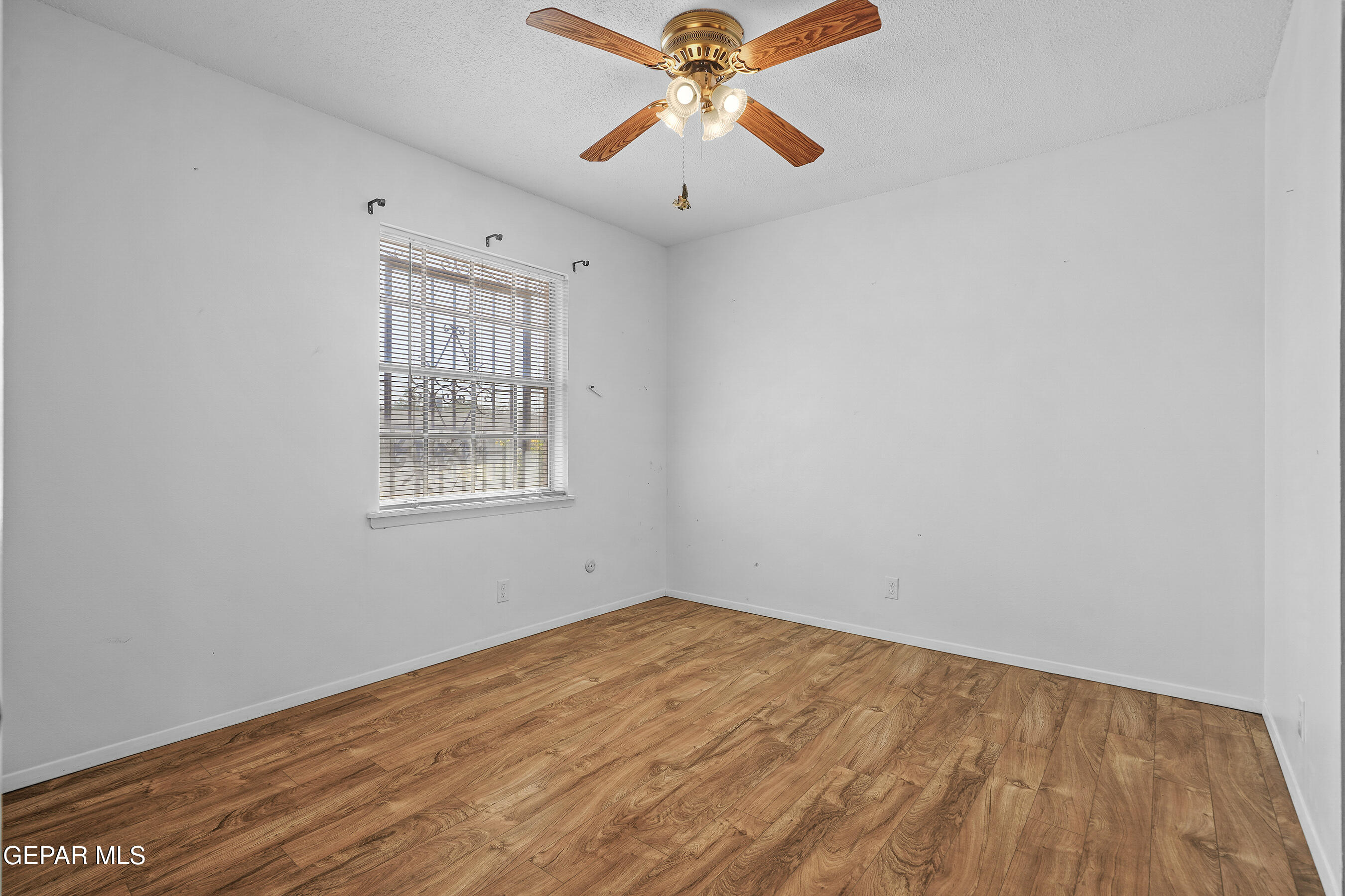 416 San Saba Road El Paso, TX 79912 - Photo 28 of 41 wooden floor in an empty room with a window