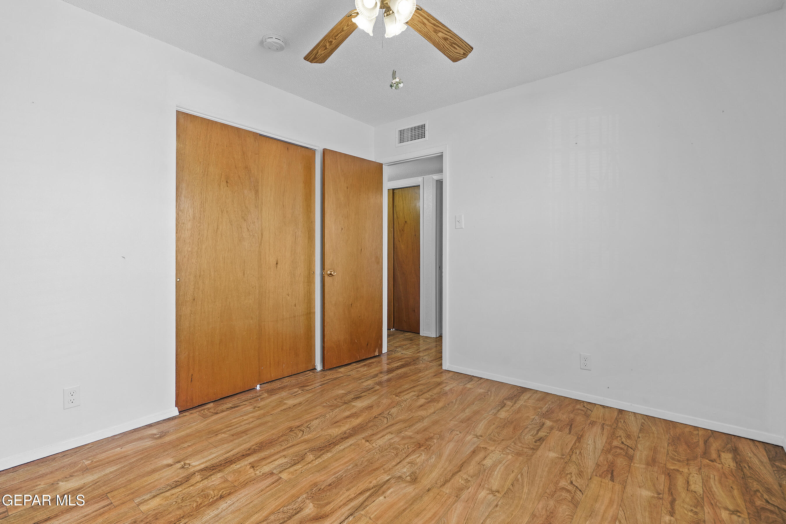 416 San Saba Road El Paso, TX 79912 - Photo 29 of 41 a view of an empty room with wooden floor