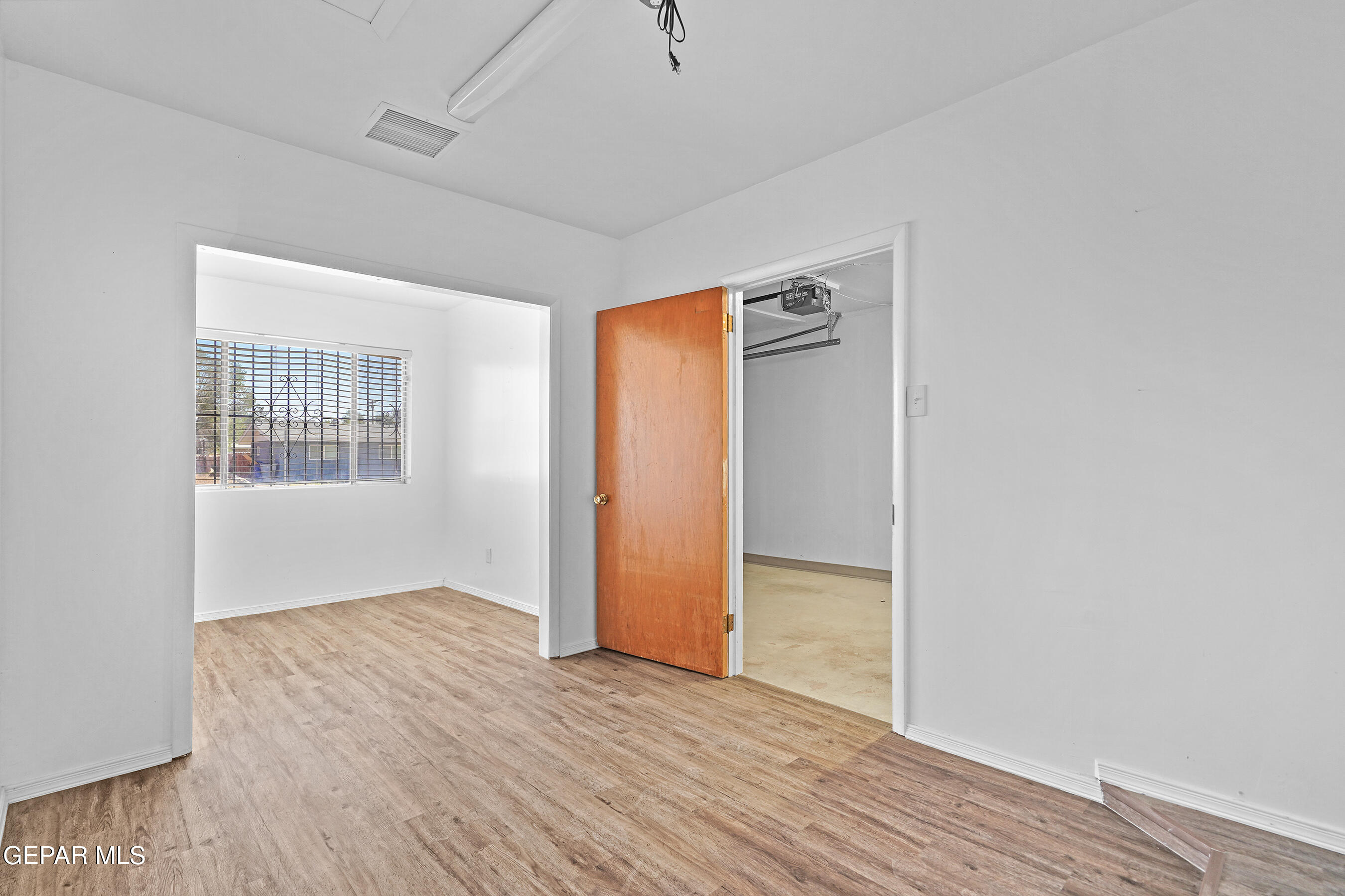 416 San Saba Road El Paso, TX 79912 - Photo 33 of 41 an empty room with wooden floor and a window