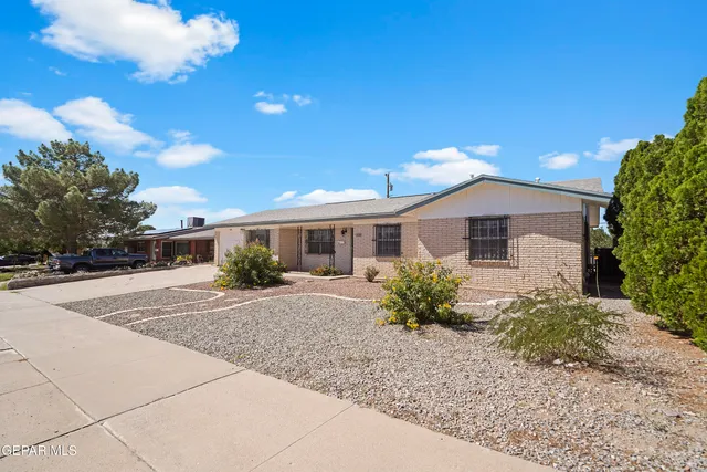 a front view of a house with a yard and a garage