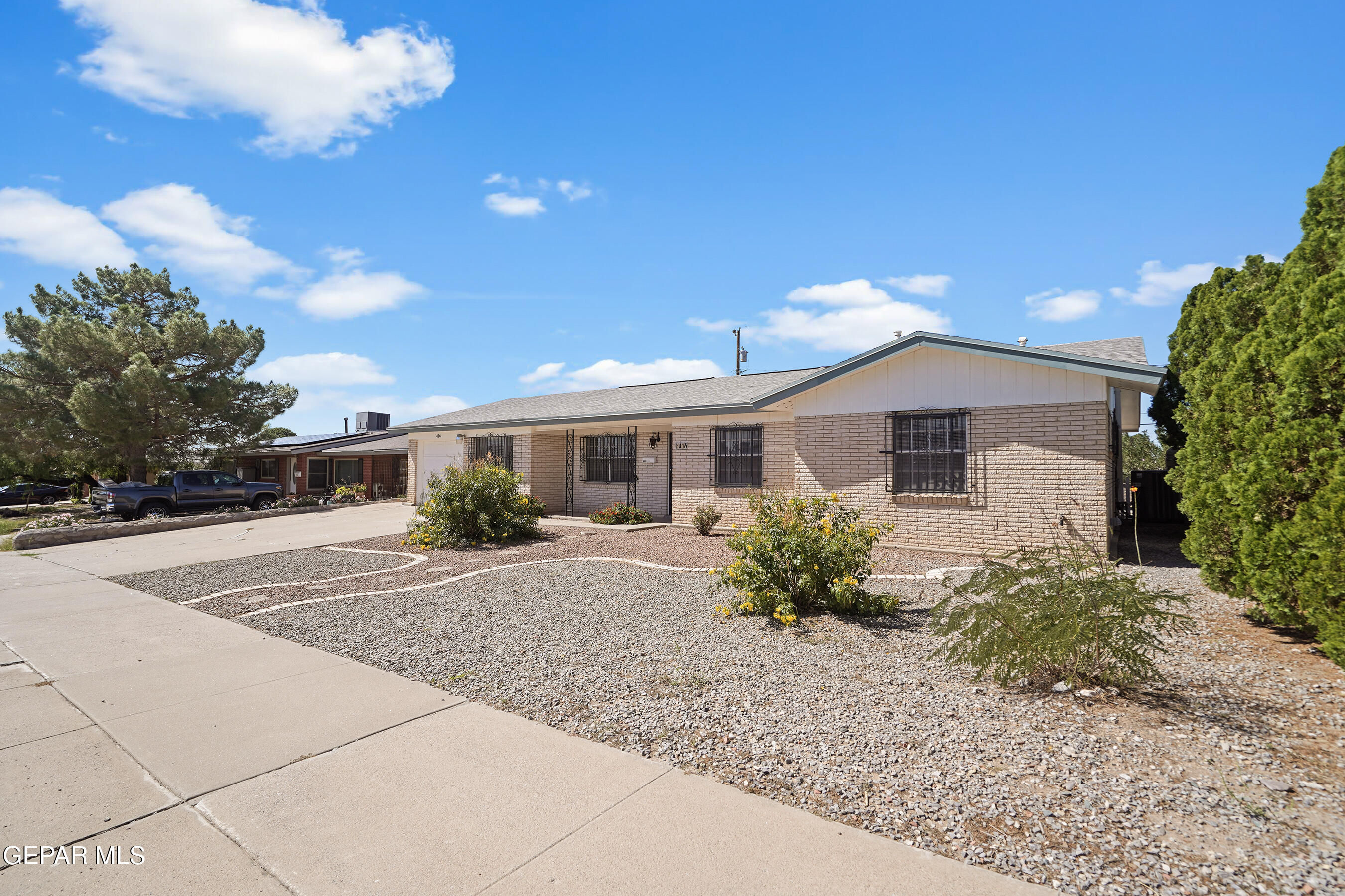 416 San Saba Road El Paso, TX 79912 - Photo 41 of 41 a front view of a house with a yard and a garage