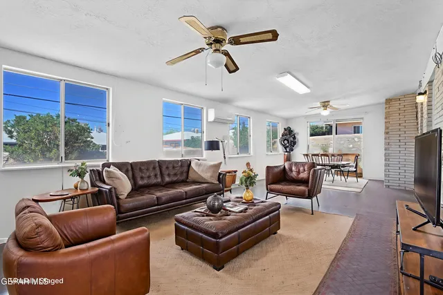 a living room with furniture ceiling fan and a rug