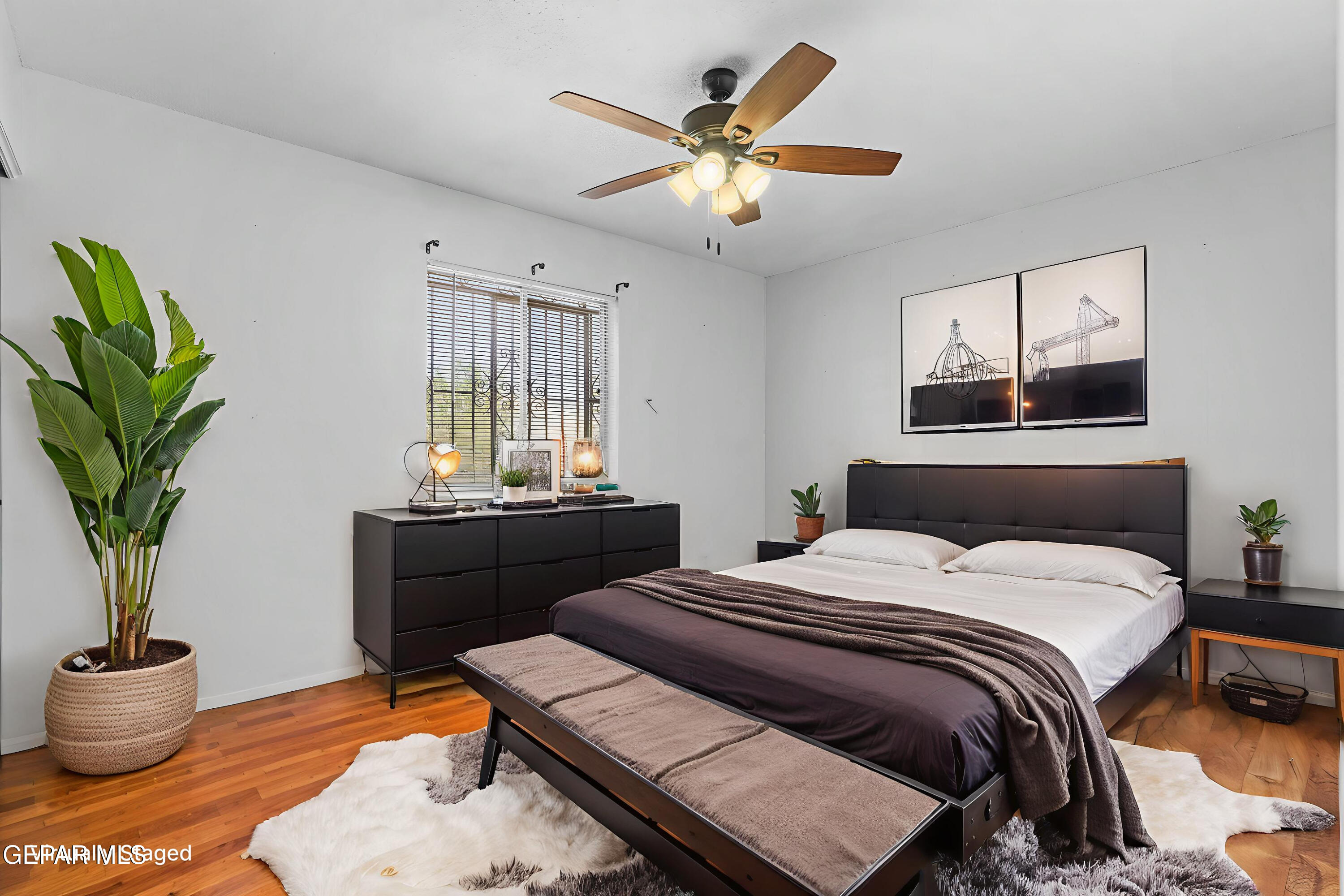 416 San Saba Road El Paso, TX 79912 - Photo 7 of 41 a bedroom with a bed and a chandelier