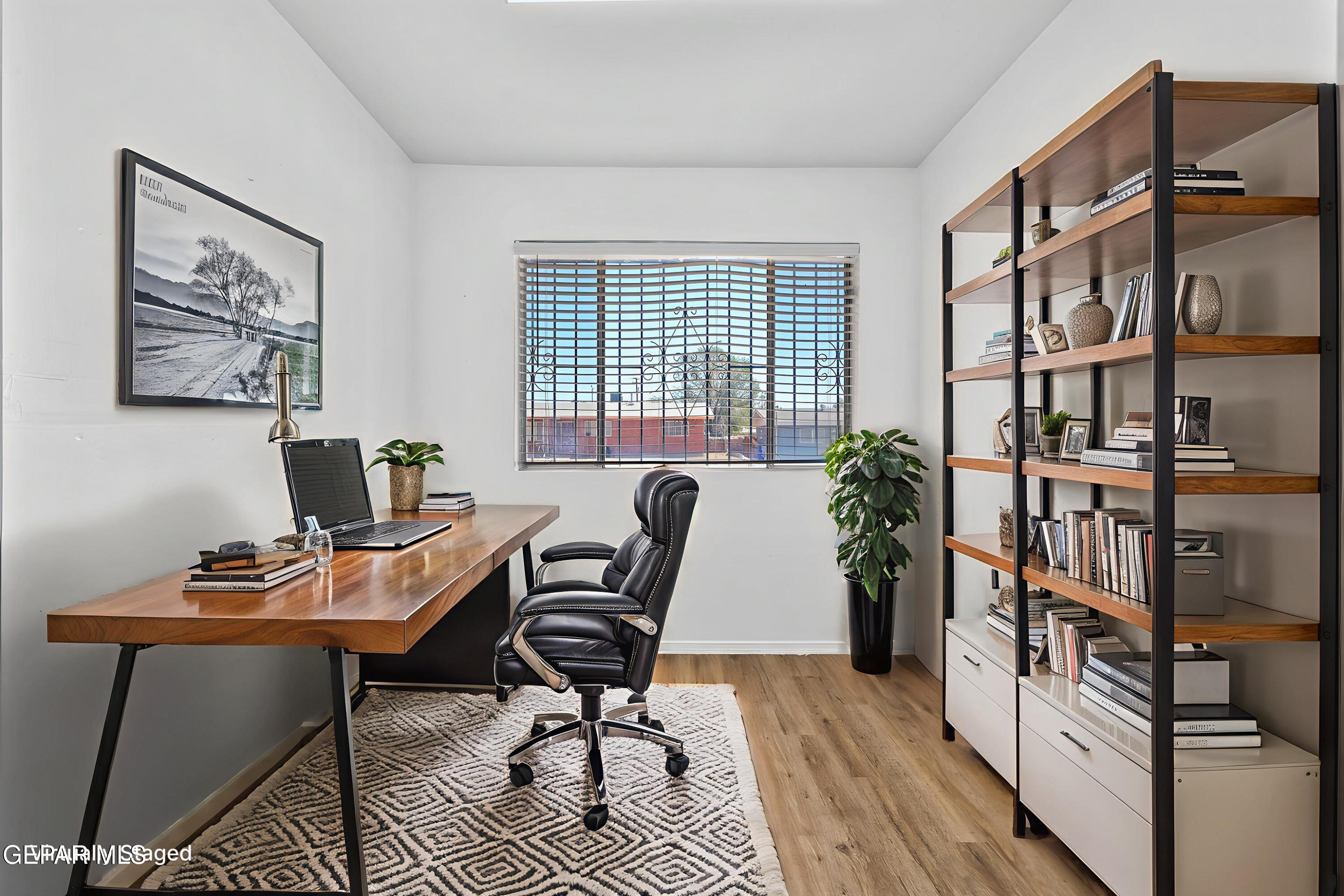 416 San Saba Road El Paso, TX 79912 - Photo 10 of 41 a workspace with furniture and book shelf
