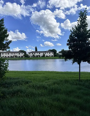 a view of a yard with a house in the background