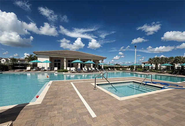 a view of a swimming pool and lounge chairs