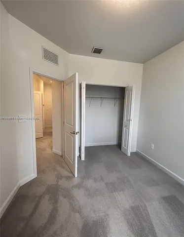 a view of an empty room and closet area