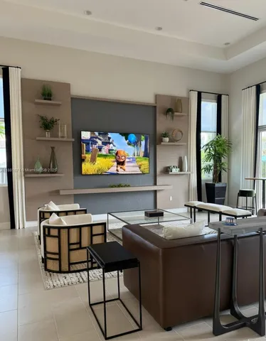 a living room with stainless steel appliances kitchen island granite countertop a sink and a stove