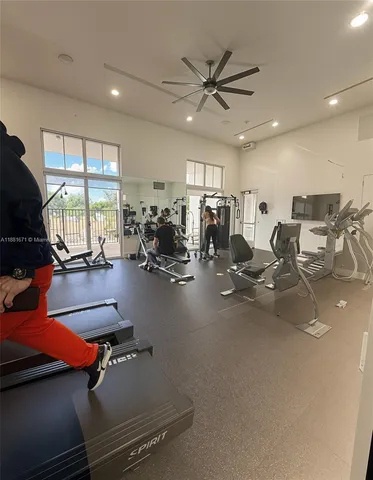 a room with gym equipment and windows