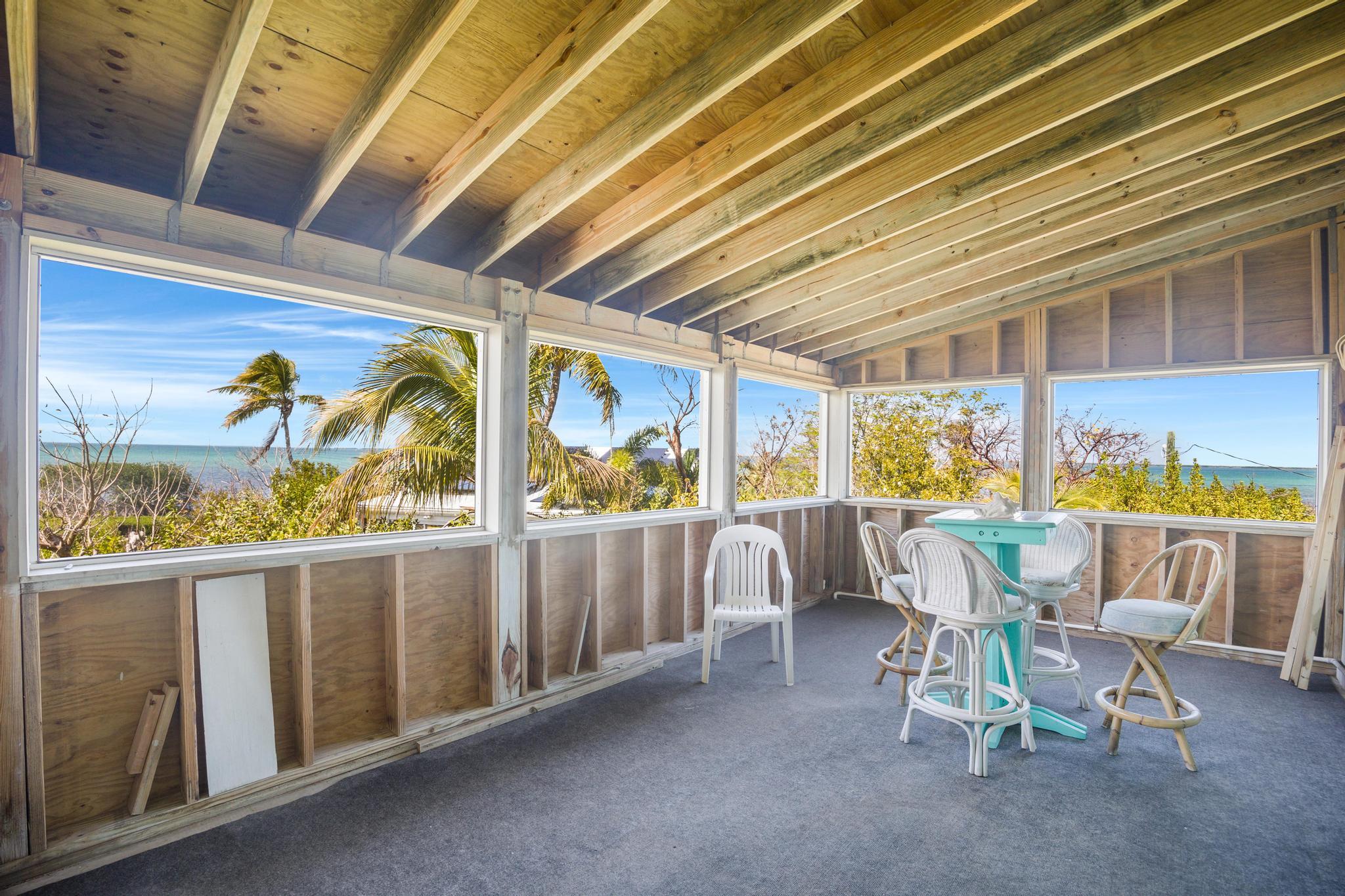 2148 Bahia Shores Road Big Pine Key, FL 33043 - Photo 17 of 35 a view of a patio with a table and chairs