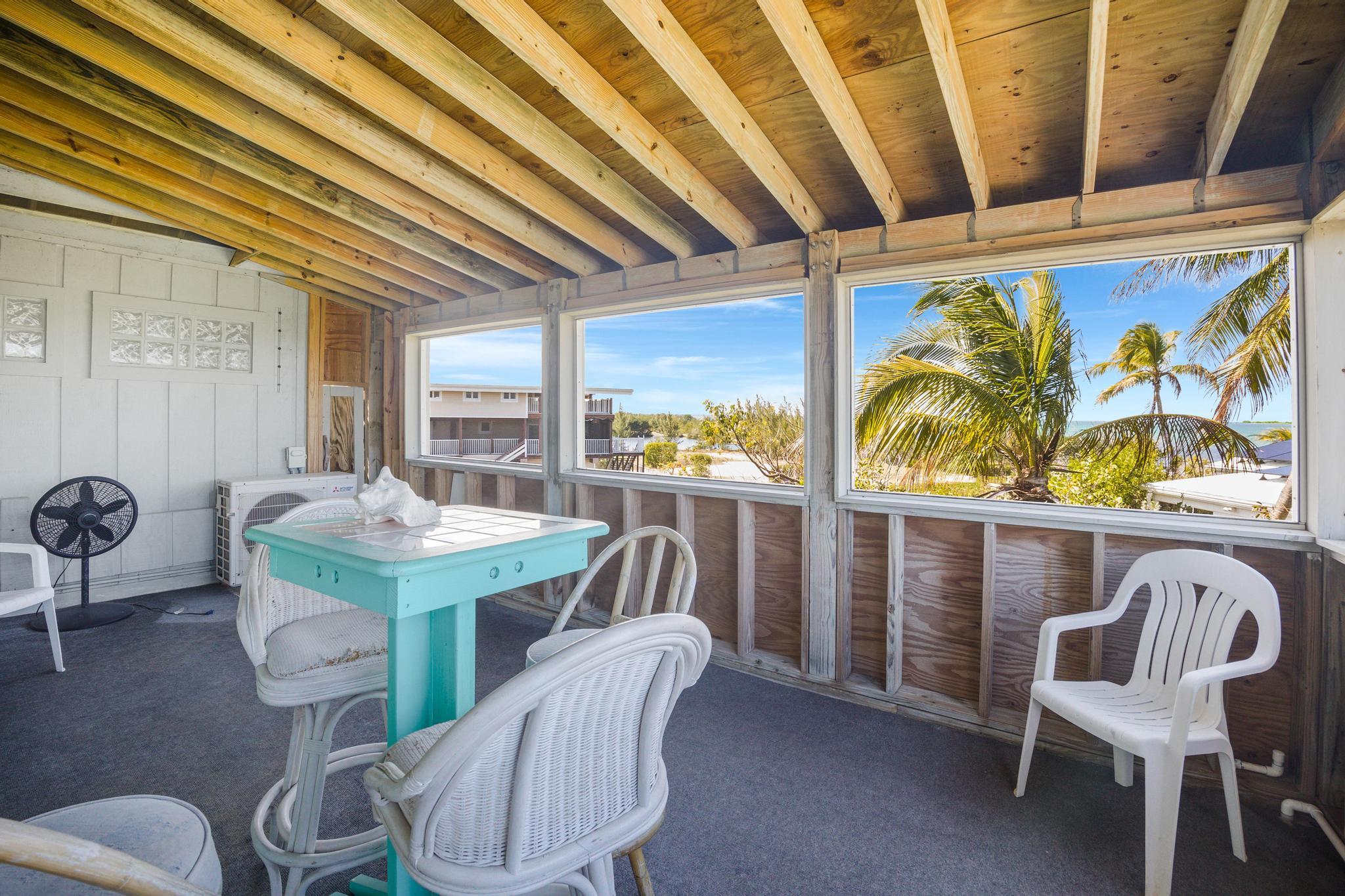 2148 Bahia Shores Road Big Pine Key, FL 33043 - Photo 18 of 35 a view of a dining room with furniture window and outside view