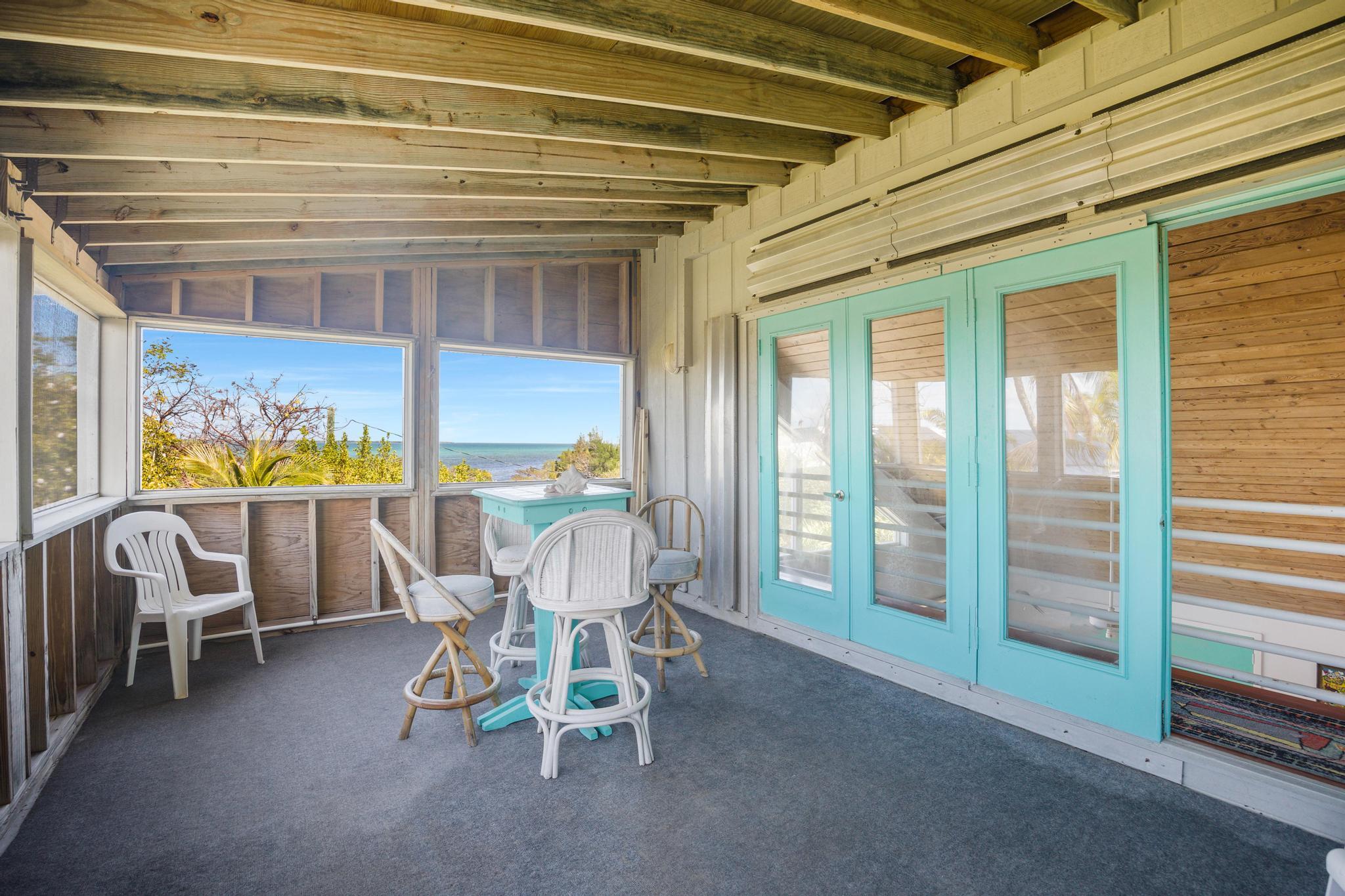 2148 Bahia Shores Road Big Pine Key, FL 33043 - Photo 20 of 35 a dining room with furniture and a floor to ceiling window