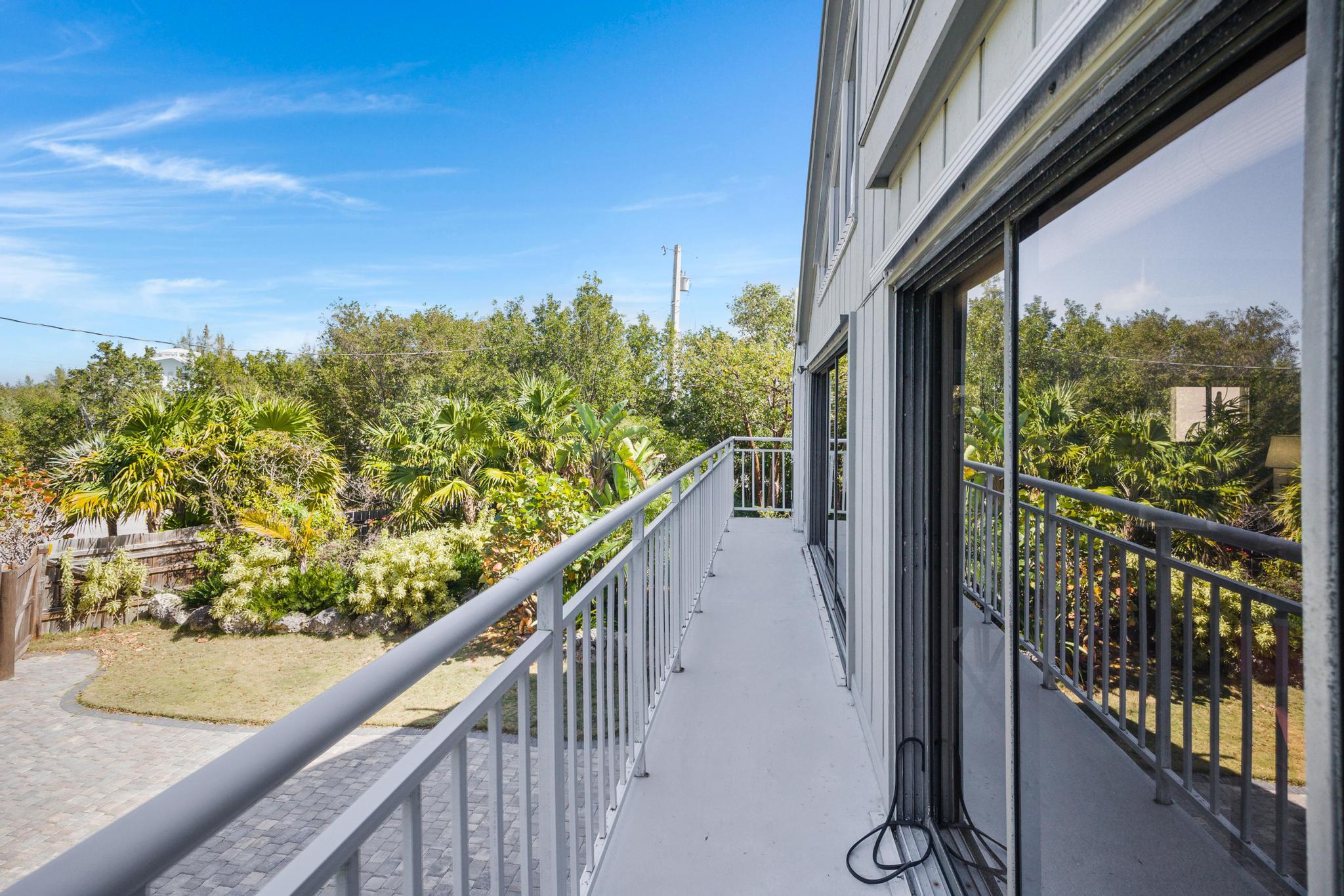 2148 Bahia Shores Road Big Pine Key, FL 33043 - Photo 22 of 35 a view of a balcony with wooden floor and fence